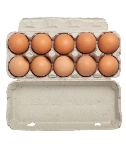 brown eggs from above in an open cardboard carton