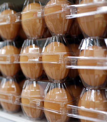 stacks of brown eggs in plastic cartons